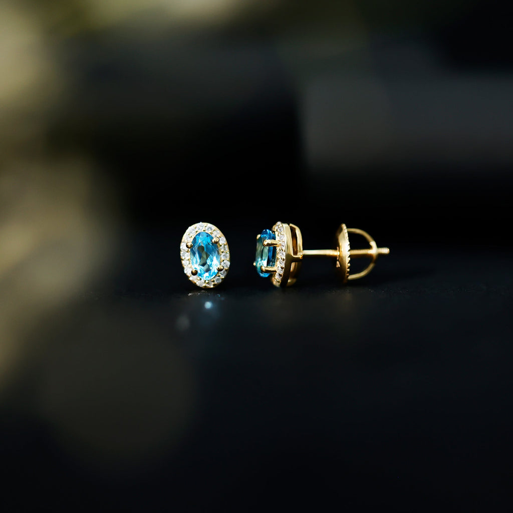 Pendientes de topacio azul suizo natural con halo de diamantes